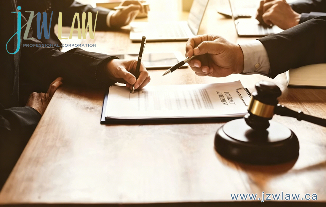 Lawyers signing a contract at a wooden table with a gavel in the foreground; logo and website visible on the image.