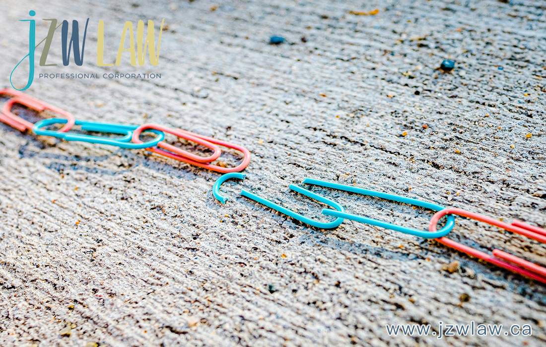 Colorful plastic chain links lie broken in the middle on a rough pavement, with the jzlaw logo in the top left and www.jzlaw.ca in the bottom right.