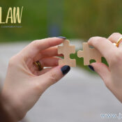 Two hands connect two puzzle pieces, symbolizing partnership, with a law firm's logo in the top-left corner.