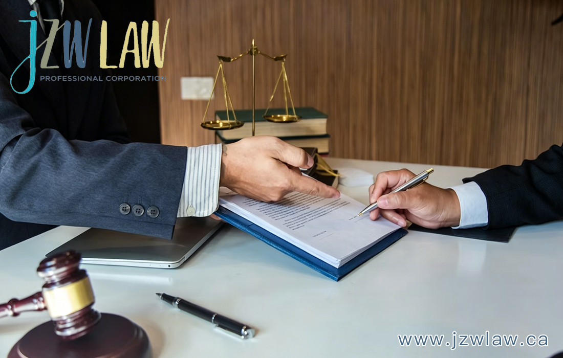 Two professionals sign a legal document at a desk, with a gavel, scales of justice, and a laptop nearby; jzwLAW branding visible in the corner.