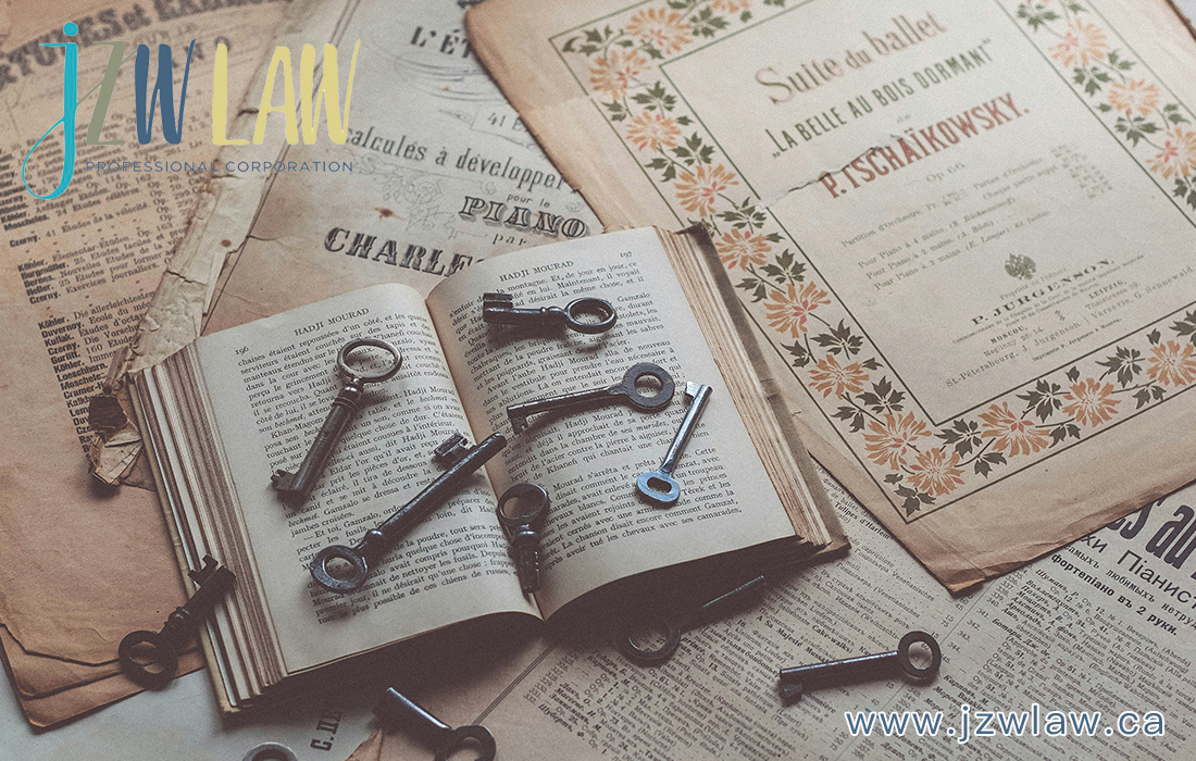 Open antique book with several old keys scattered on its pages amid aged papers and a JZ Law branding watermark.
