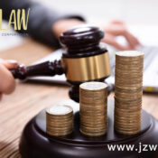 Gavel striking coins stacked on a desk, with jzwLAW branding in the top left and www.jzwlaw.ca in the bottom right.