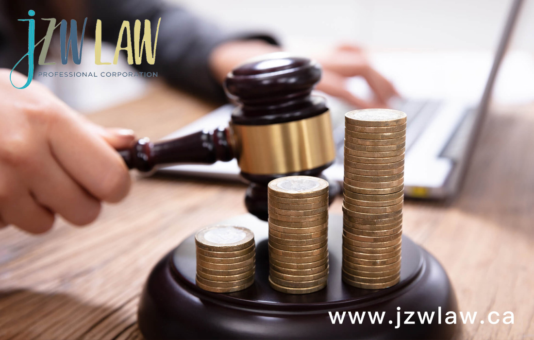 Gavel striking coins stacked on a desk, with jzwLAW branding in the top left and www.jzwlaw.ca in the bottom right.