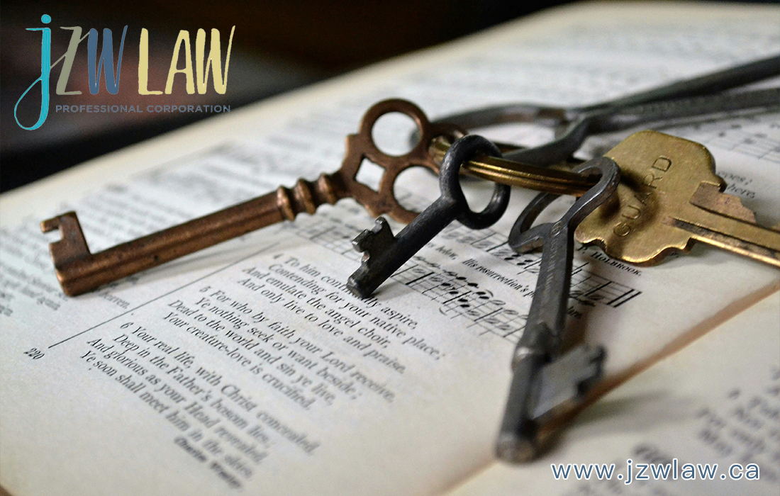 Close-up of vintage keys resting on an open book, with the JZW Law Professional Corporation logo in the top-left and the site address www.jzwlaw.ca visible at the bottom.