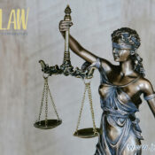 Statue of Lady Justice holding scales, with a law firm logo in the top left and the website at bottom right.
